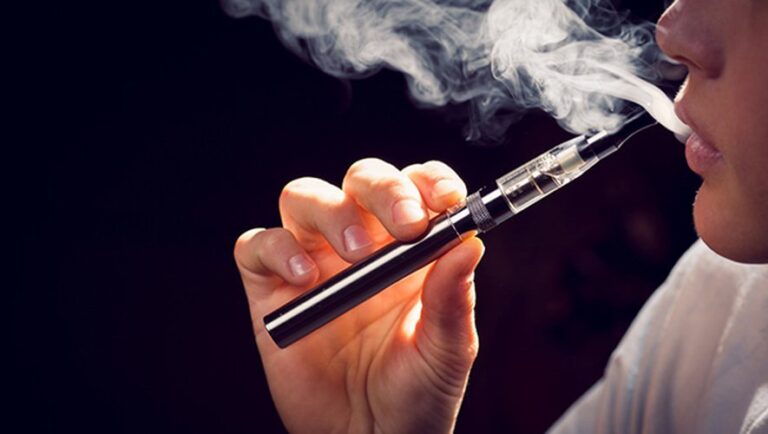 Close up of inhaling from an electronic cigarette.