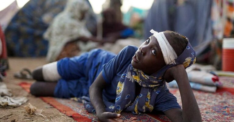 Displaced people, who fled from al-Fashir, spend time at a camp in Tawila